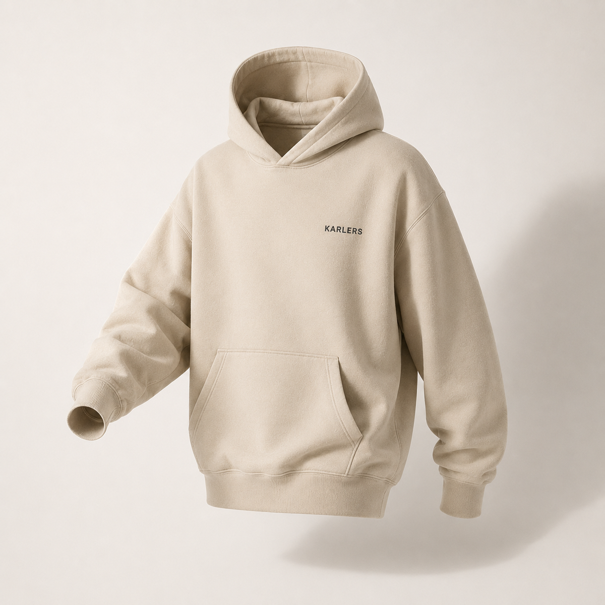 KARLERS Essential Hoodie in oat, three-quarter view showing the dropped shoulder